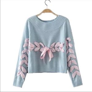 Cute baby blue sweater with pink ribbons